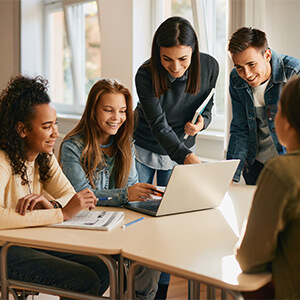 teacher working with high school students